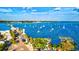 Aerial view of a wooden pier with sailboats on the water and cars parked along the waterfront at 5718 Garden Lakes Palm, Bradenton, FL 34203