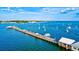 Stunning aerial view of a wooden pier on Anna Maria Island with sailboats on a sunny day at 5718 Garden Lakes Palm, Bradenton, FL 34203