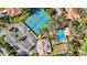 Overhead view of the tennis courts, community pool and clubhouse, all in a lush green setting at 5718 Garden Lakes Palm, Bradenton, FL 34203