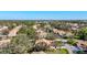 Extensive aerial shot captures the community's layout with numerous homes nestled among mature trees at 5718 Garden Lakes Palm, Bradenton, FL 34203