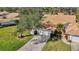 Aerial view of home featuring lush landscaping, a brick driveway, and a well-maintained tile roof at 5718 Garden Lakes Palm, Bradenton, FL 34203