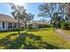 Expansive backyard featuring lush greenery, mature trees, and a well-manicured lawn at 5718 Garden Lakes Palm, Bradenton, FL 34203