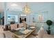 Light-filled dining room showcases mirrored accents, glass-top table, seating for six, and calming decor at 5718 Garden Lakes Palm, Bradenton, FL 34203