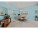 Elegant dining room with a chandelier, a large mirror, and seating for six at 5718 Garden Lakes Palm, Bradenton, FL 34203