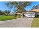 Brick driveway and manicured lawn lead to this lovely single-story home with a tile roof at 5718 Garden Lakes Palm, Bradenton, FL 34203