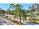 Community entrance with a manicured landscape, white picket fence, and a welcoming palm tree at 5718 Garden Lakes Palm, Bradenton, FL 34203