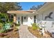 Charming front entrance with beautiful landscaping, a decorative door, and a lovely fountain at 5718 Garden Lakes Palm, Bradenton, FL 34203