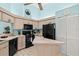 Bright kitchen with black appliances, light wood cabinets, a center island, and tile floors at 5718 Garden Lakes Palm, Bradenton, FL 34203