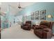 Inviting living room with two plush recliners, light blue walls, and a vaulted ceiling with ceiling fan at 5718 Garden Lakes Palm, Bradenton, FL 34203