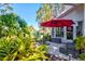 Inviting patio area with stylish outdoor seating and lush landscaping at 5718 Garden Lakes Palm, Bradenton, FL 34203