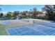 Well-maintained tennis courts with lush greenery and mature trees creating a serene atmosphere at 5718 Garden Lakes Palm, Bradenton, FL 34203