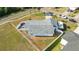 Aerial view featuring the property's fenced yard, home layout, and location on a corner lot in a residential area at 6001 Firefly Ln, Apollo Beach, FL 33572