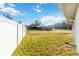 Expansive backyard with lush lawn and privacy fence at 6001 Firefly Ln, Apollo Beach, FL 33572