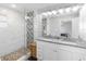 Bathroom featuring a glass door shower and white cabinets with a granite countertop at 6001 Firefly Ln, Apollo Beach, FL 33572