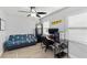 Light-filled bedroom with a ceiling fan, wooden flooring and a comfortable futon at 6001 Firefly Ln, Apollo Beach, FL 33572