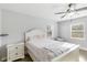 Bright bedroom featuring a ceiling fan, closet, and a window allowing natural light at 6001 Firefly Ln, Apollo Beach, FL 33572