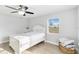 Bright bedroom featuring a ceiling fan, closet, and a window allowing natural light at 6001 Firefly Ln, Apollo Beach, FL 33572