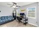 Neutral bedroom featuring a futon, desk and chair, and a ceiling fan at 6001 Firefly Ln, Apollo Beach, FL 33572