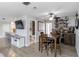 Cozy dining area features modern light fixture, wet bar, and convenient access to the kitchen at 6001 Firefly Ln, Apollo Beach, FL 33572