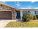 Close up of the front entrance with stone accents and a well-manicured lawn at 6001 Firefly Ln, Apollo Beach, FL 33572