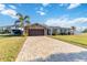 Inviting single-story home showcasing a paved driveway leading to an attached two-car garage at 6001 Firefly Ln, Apollo Beach, FL 33572