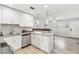 Bright kitchen features white cabinets, stainless steel appliances, granite countertops, and pendant lighting at 6001 Firefly Ln, Apollo Beach, FL 33572