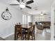 Well-lit living area featuring a dining table and a comfortable brown sofa set at 6001 Firefly Ln, Apollo Beach, FL 33572