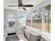 Inviting sunroom filled with natural light, featuring tiled floors and multiple windows at 6001 Firefly Ln, Apollo Beach, FL 33572