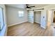 Bedroom with sliding closet door, ceiling fan, white walls, and wood-look flooring at 6226 21St N Ave, St Petersburg, FL 33710