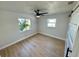 Bedroom with wood-look flooring, ceiling fan, and view from the window at 6226 21St N Ave, St Petersburg, FL 33710