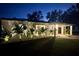 Well-lit front exterior at night, featuring landscaped yard and a contemporary design at 6226 21St N Ave, St Petersburg, FL 33710