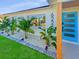 Beautifully landscaped front yard with a vibrant blue front door and modern house number at 6226 21St N Ave, St Petersburg, FL 33710