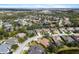 A beautiful aerial view of a residential community with mature trees and landscaping and a large pond at 6373 Royal Tern Cir, Lakewood Ranch, FL 34202