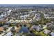 Scenic aerial view of a neighborhood with a tranquil pond, mature trees, and well-maintained homes at 6373 Royal Tern Cir, Bradenton, FL 34202