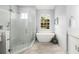 Modern bathroom showcasing a glass shower, soaking tub, and elegant finishes at 6373 Royal Tern Cir, Bradenton, FL 34202