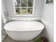 Elegant bathroom highlighting a freestanding tub, window, and modern fixtures at 6373 Royal Tern Cir, Bradenton, FL 34202