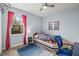 Cozy bedroom with natural light, featuring a boat style bed frame, and wood grain flooring at 6373 Royal Tern Cir, Bradenton, FL 34202