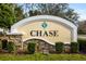 Landscaped Chase Community signage with stacked stone and a well-maintained garden at 6373 Royal Tern Cir, Lakewood Ranch, FL 34202