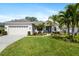 Well-maintained home with green lawn, lush landscaping, and attached garage at 6373 Royal Tern Cir, Bradenton, FL 34202