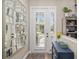 Bright foyer featuring a mirrored accent wall, wood floors, and views of the outdoors at 6373 Royal Tern Cir, Bradenton, FL 34202