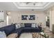 Comfortable living room featuring a coffered ceiling, modern decor, and large sectional sofa at 6373 Royal Tern Cir, Bradenton, FL 34202