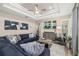 Comfortable living room featuring a coffered ceiling, modern decor, and large sectional sofa at 6373 Royal Tern Cir, Lakewood Ranch, FL 34202