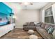 Inviting living room featuring a large gray sectional sofa, a blue accent wall, and stylish decor at 6373 Royal Tern Cir, Bradenton, FL 34202