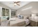 Bright main bedroom boasts a ceiling fan, slider to the pool, and neutral tones at 6373 Royal Tern Cir, Bradenton, FL 34202