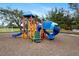 A colorful community playground with slides, climbing structures, and benches for parents to relax at 6373 Royal Tern Cir, Bradenton, FL 34202