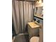 Compact bathroom with a shower curtain, neutral-colored sink, and ample lighting at 640 Dalton Blvd, Port Charlotte, FL 33952