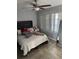 Cozy bedroom featuring a ceiling fan, a plush bed, and bright natural light at 640 Dalton Blvd, Port Charlotte, FL 33952