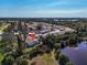 Aerial view of home next to pond, showcasing the property's serene setting and community layout at 6796 Gasparilla Pines Blvd # 45, Englewood, FL 34224