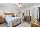 Bright bedroom with a queen size bed and a view into the en suite bathroom at 6796 Gasparilla Pines Blvd # 45, Englewood, FL 34224