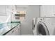 Laundry room features a washing machine, dryer, and cabinets for additional storage at 6796 Gasparilla Pines Blvd # 45, Englewood, FL 34224